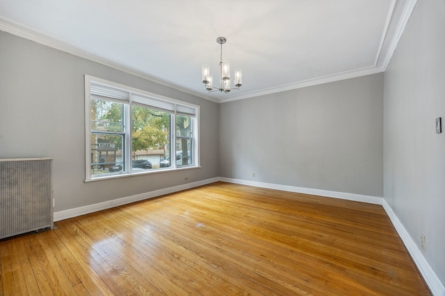 unfurnished room with light hardwood / wood-style floors, radiator heating unit, an inviting chandelier, and crown molding