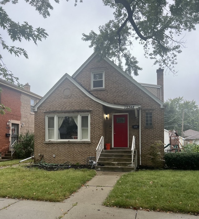 bungalow-style house featuring a front yard