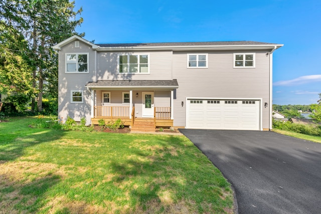 view of property with a garage, a porch, and a front yard