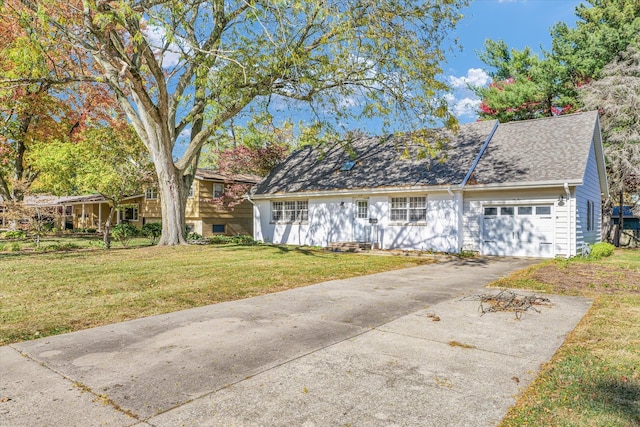 view of front of property with a front yard and a garage