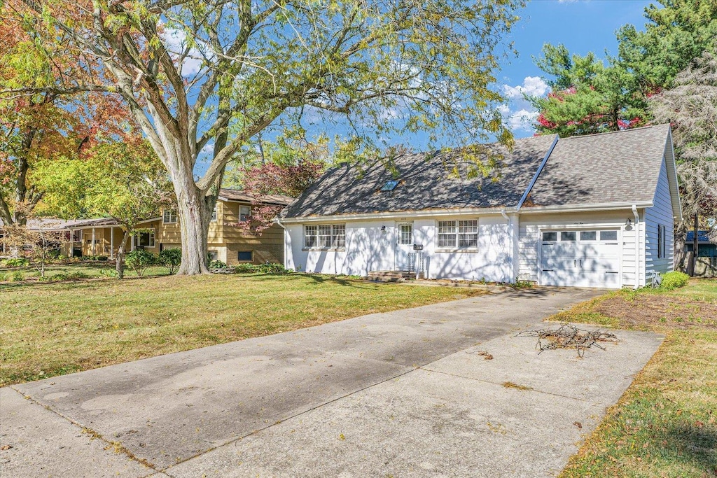 610 E Burkwood Ct, Urbana, IL 61801 - view of front of property with a front yard and a garage