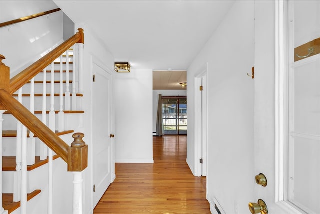 corridor with light hardwood / wood-style flooring