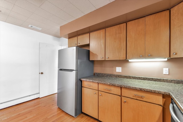 kitchen with light wood-type flooring, appliances with stainless steel finishes, and baseboard heating