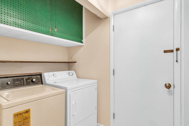 clothes washing area with washing machine and clothes dryer