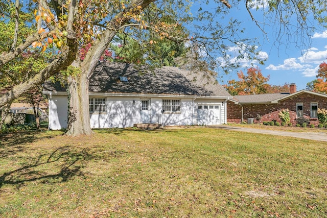 view of front of property with a garage and a front lawn