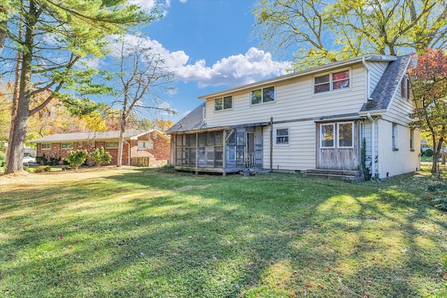 back of property with a sunroom and a yard