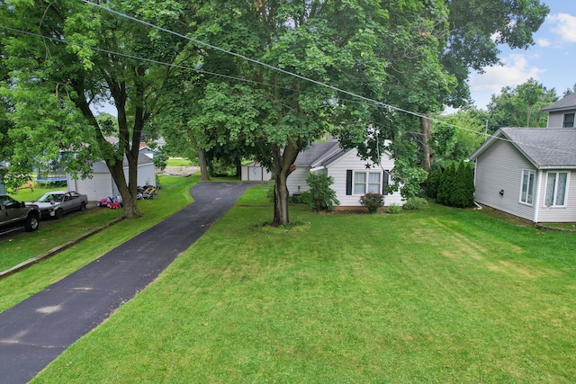 view of front of property with a garage and a front lawn