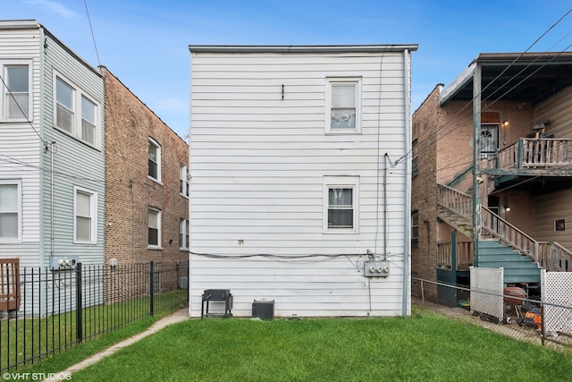 rear view of house featuring a yard