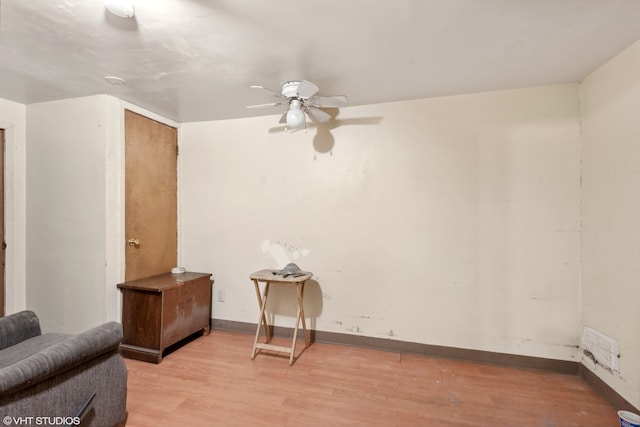 sitting room featuring ceiling fan and light hardwood / wood-style flooring