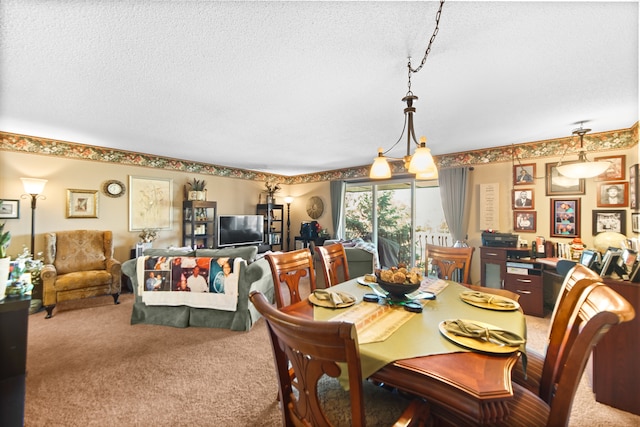 carpeted dining room with a textured ceiling and an inviting chandelier