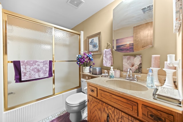 full bathroom featuring combined bath / shower with glass door, vanity, and toilet