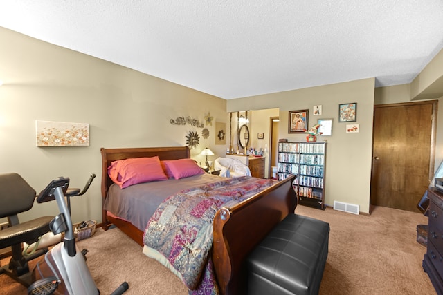 carpeted bedroom with a textured ceiling