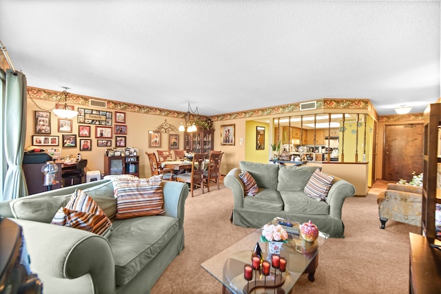 carpeted living room featuring a textured ceiling and an inviting chandelier