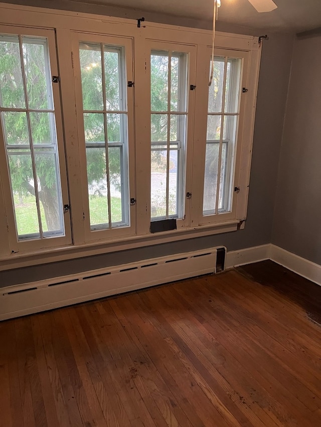 entryway featuring baseboard heating, dark hardwood / wood-style floors, and ceiling fan