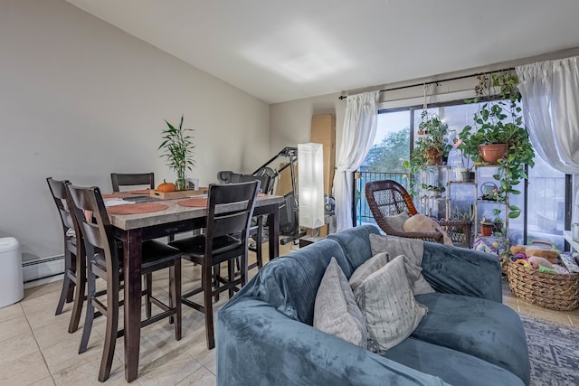 tiled dining room with vaulted ceiling and a baseboard heating unit