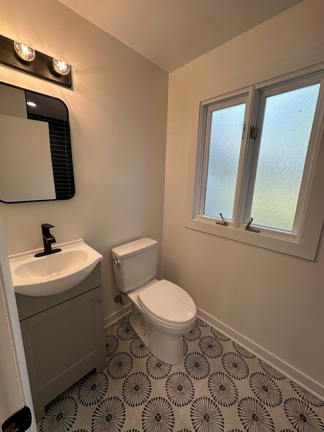 bathroom with vanity, tile patterned floors, and toilet