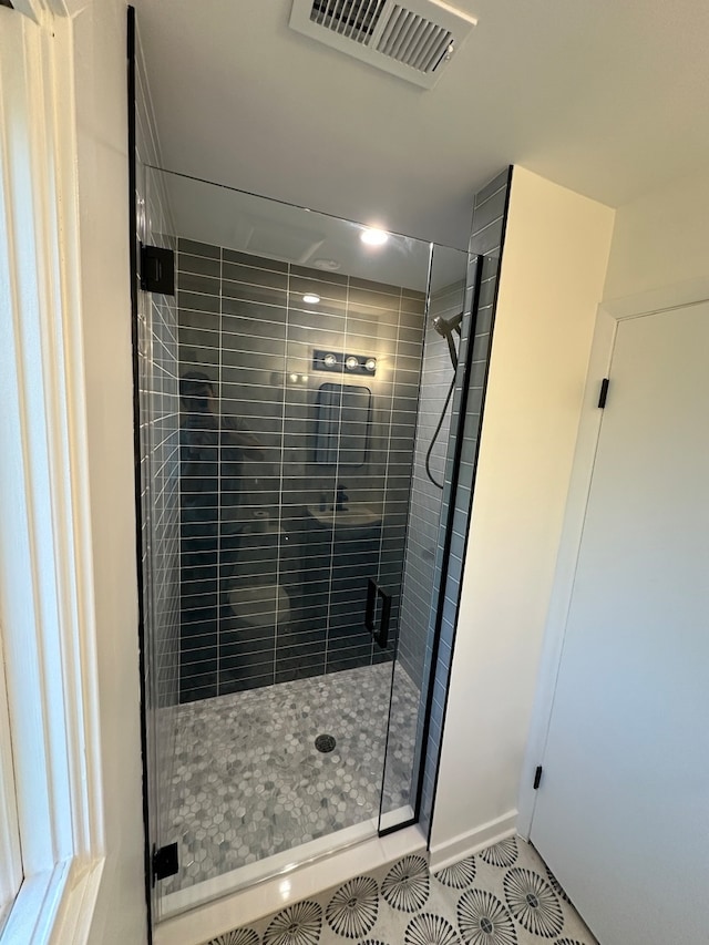 bathroom featuring walk in shower and tile patterned flooring