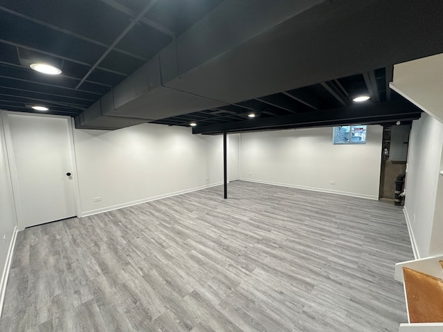 basement with hardwood / wood-style flooring