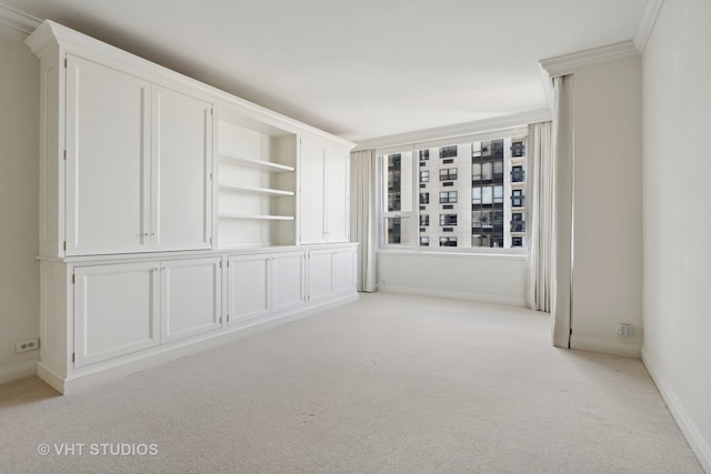 unfurnished room featuring light colored carpet and ornamental molding