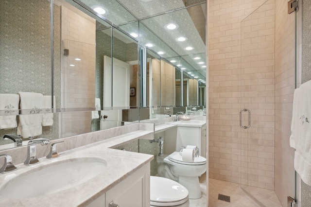 bathroom with tile patterned floors, an enclosed shower, a drop ceiling, vanity, and toilet