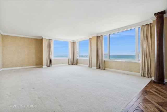 unfurnished room with crown molding, a water view, a beach view, and parquet flooring