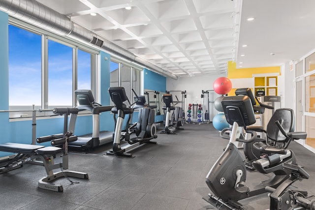 workout area with coffered ceiling