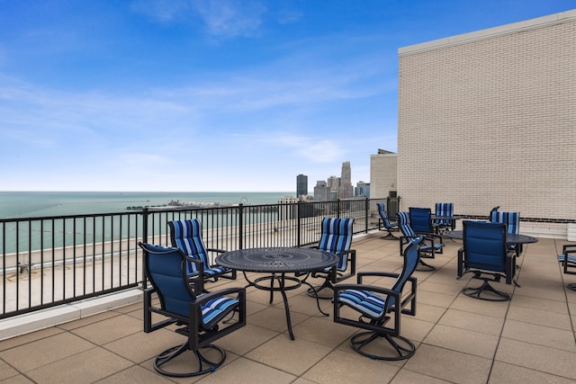 view of patio / terrace with a water view and a view of the beach