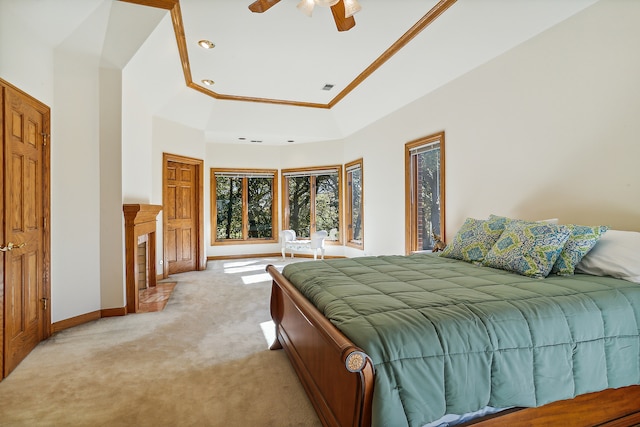 carpeted bedroom featuring ceiling fan and crown molding