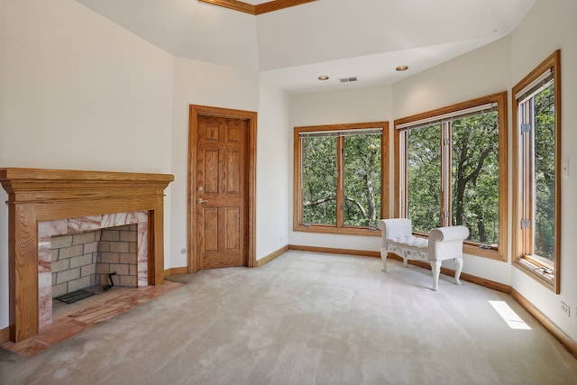 unfurnished room featuring a fireplace and light colored carpet