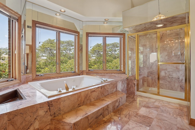 bathroom featuring independent shower and bath