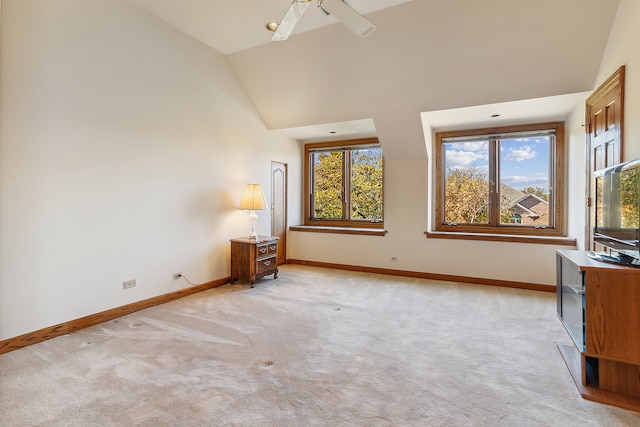 unfurnished bedroom with high vaulted ceiling, light colored carpet, and ceiling fan