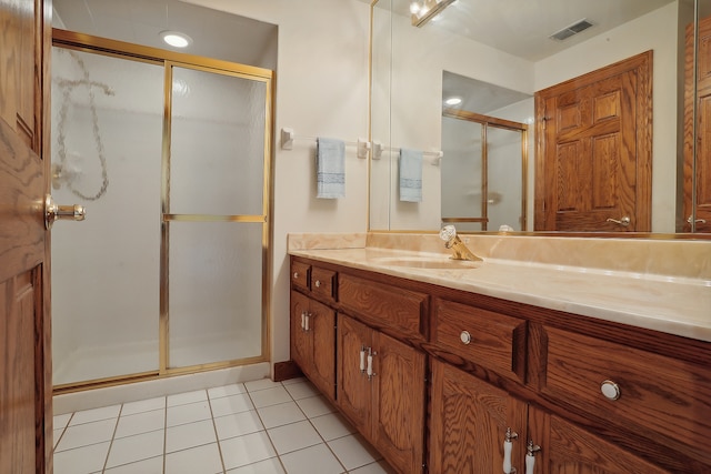 bathroom featuring walk in shower, tile patterned flooring, and vanity