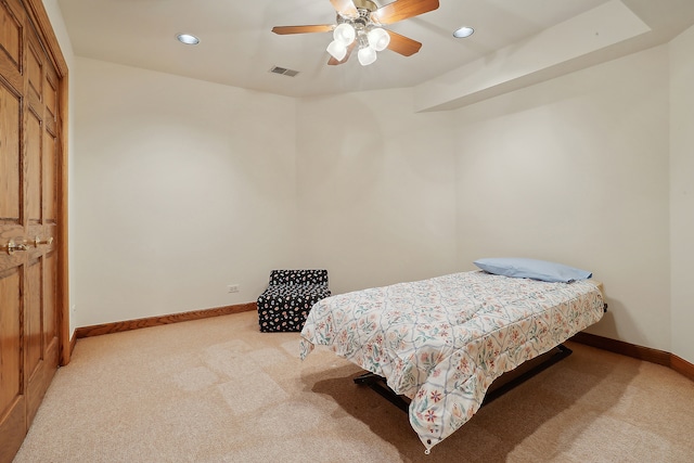 bedroom with light carpet and ceiling fan