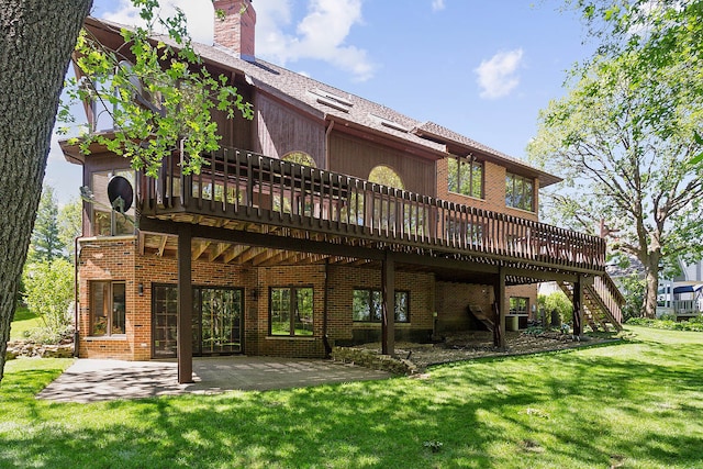 back of house with a patio, a yard, and a wooden deck