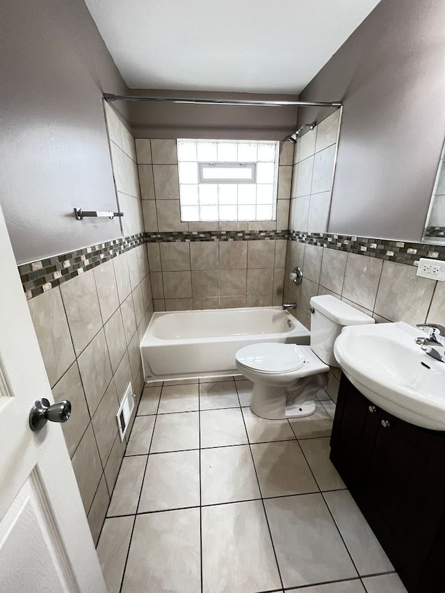 full bathroom with tile walls, vanity, tile patterned floors, and toilet