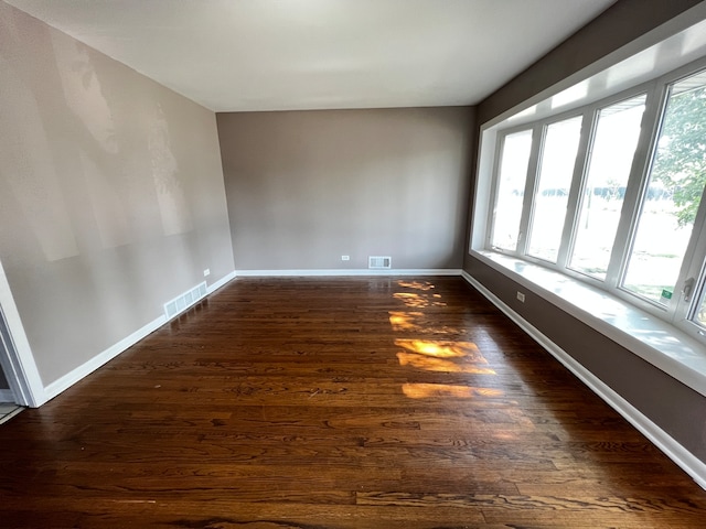 empty room with dark wood-type flooring