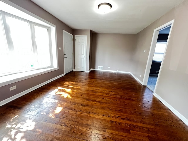 spare room with dark wood-type flooring