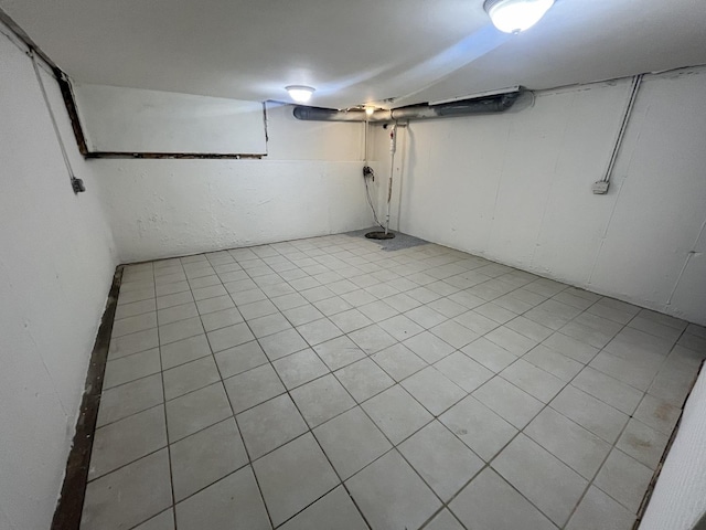 basement featuring light tile patterned floors