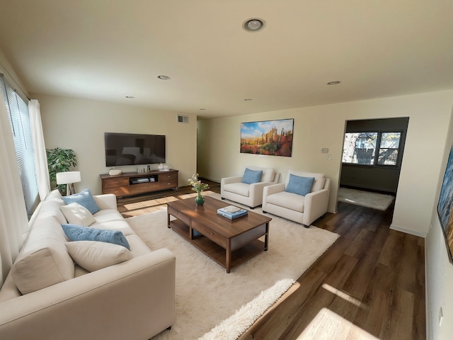 living room with a healthy amount of sunlight and dark hardwood / wood-style floors