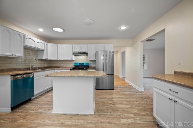 kitchen with white cabinets, light hardwood / wood-style floors, sink, and appliances with stainless steel finishes