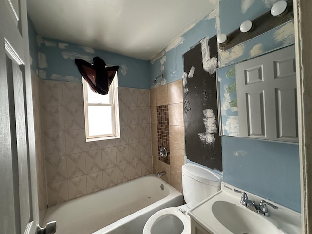 full bathroom with vanity, tiled shower / bath combo, and toilet