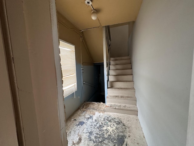 staircase featuring lofted ceiling