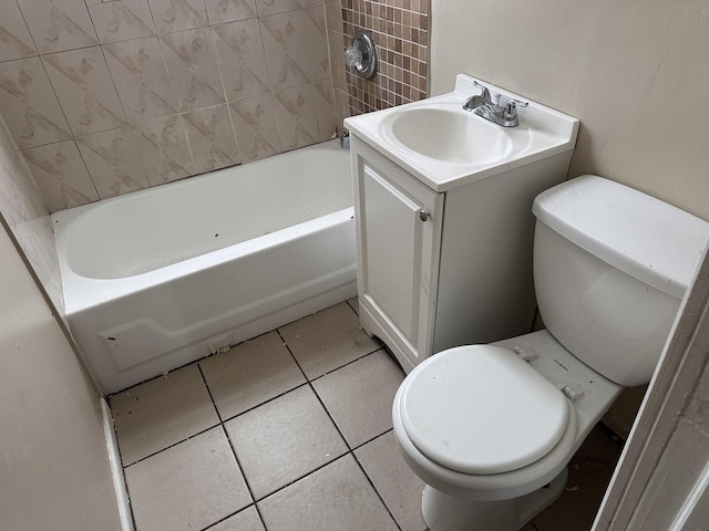 bathroom with a bath, vanity, toilet, and tile patterned floors