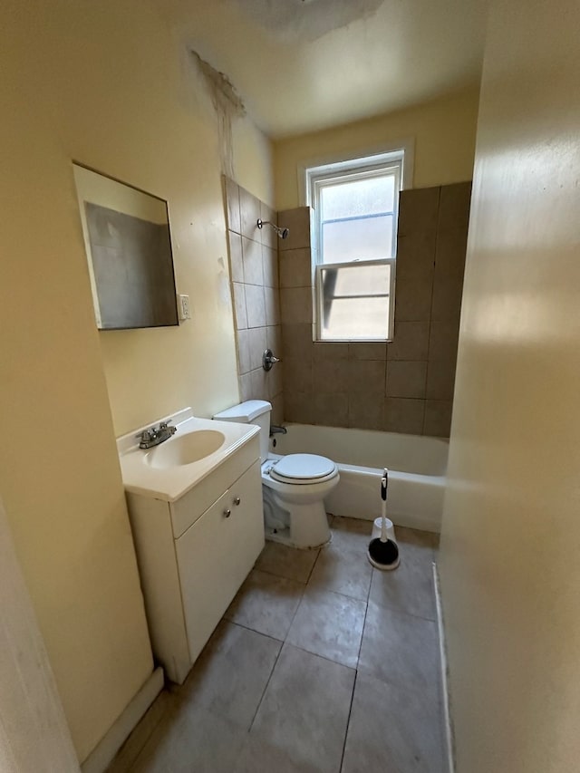 full bathroom featuring toilet, vanity, tiled shower / bath, and tile patterned flooring