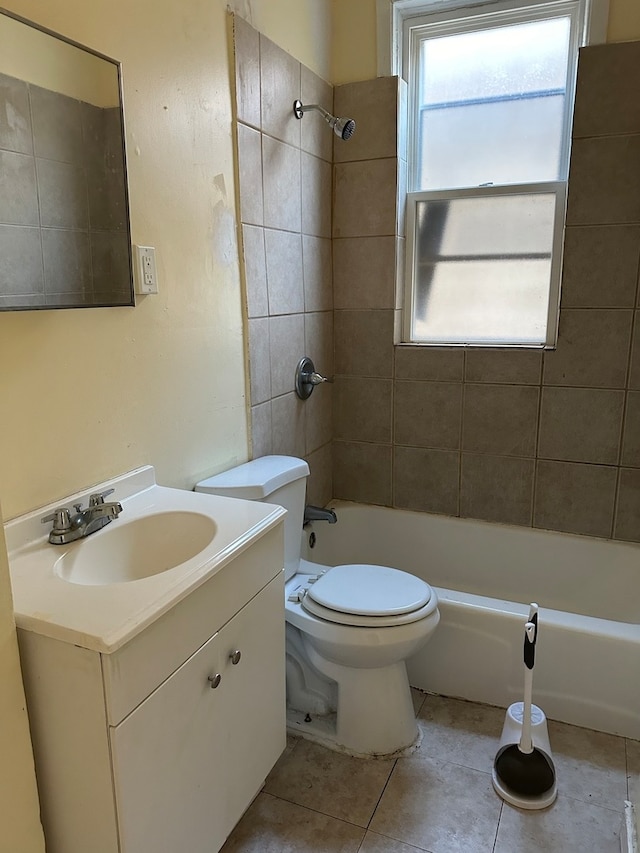 full bathroom featuring tile patterned flooring, vanity, toilet, and tiled shower / bath