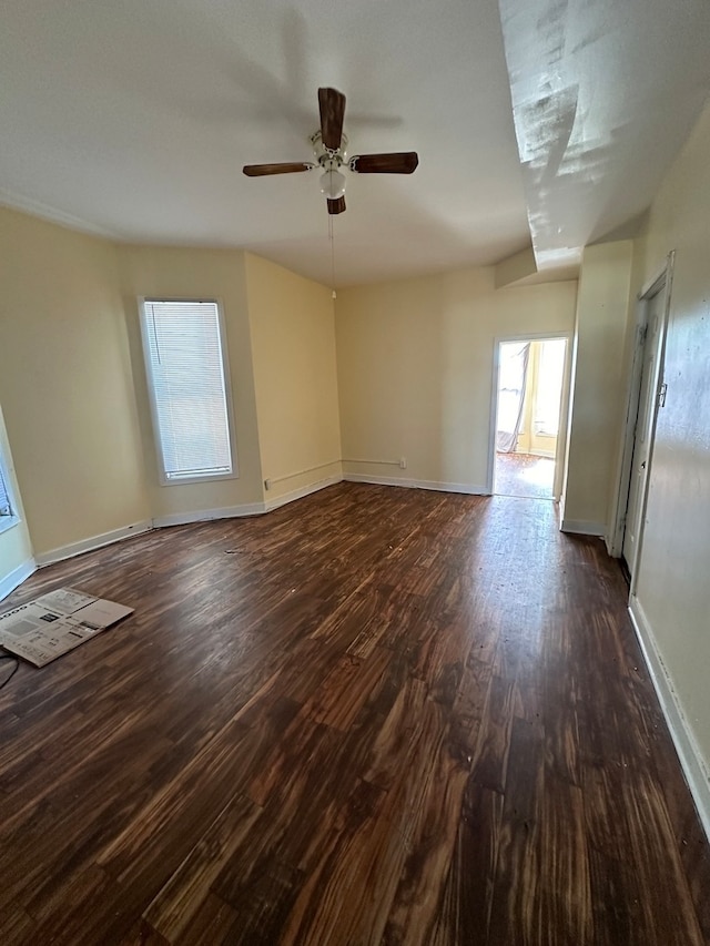 spare room with ceiling fan and dark hardwood / wood-style floors