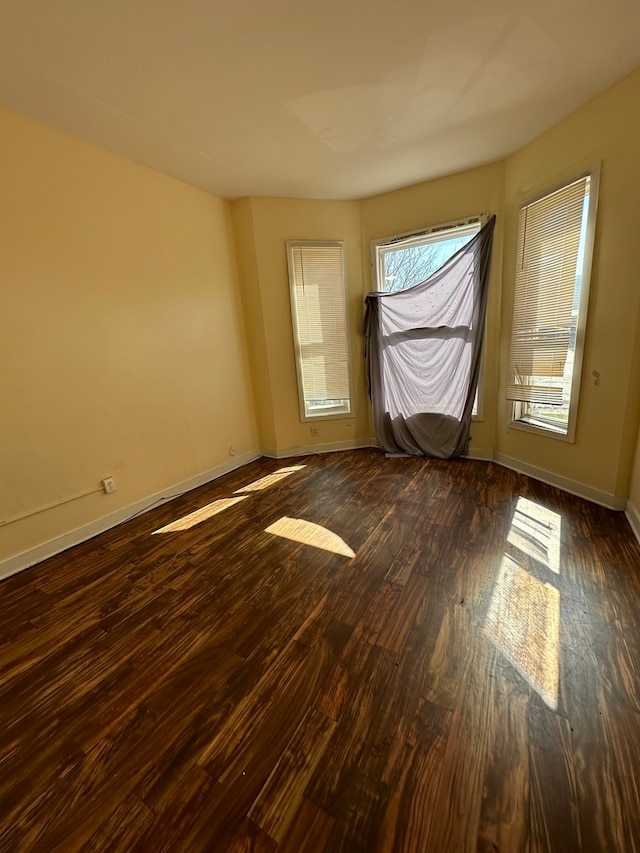 unfurnished room featuring dark hardwood / wood-style floors