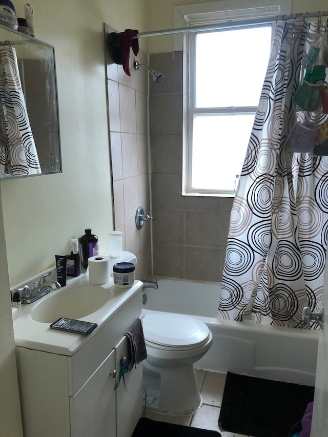 full bathroom with toilet, shower / tub combo, vanity, and a healthy amount of sunlight