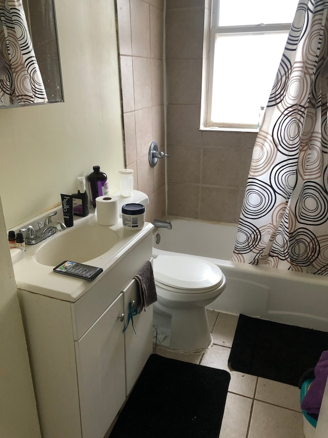 full bathroom featuring toilet, vanity, tile patterned floors, and shower / tub combo