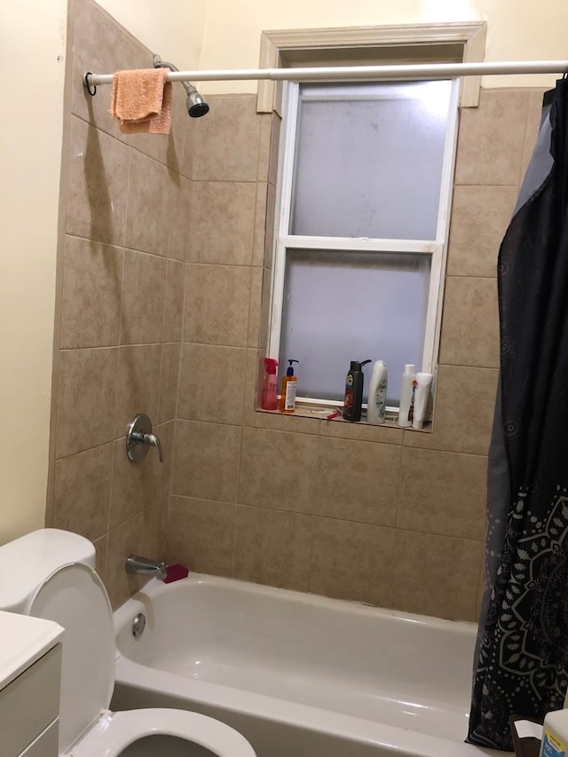 full bathroom with shower / bath combo with shower curtain, vanity, and toilet